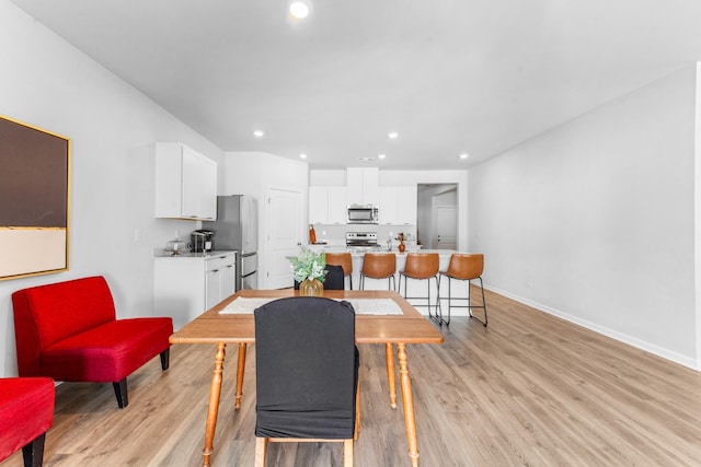 dining area featuring light wood-type flooring