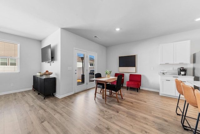 dining area with light hardwood / wood-style floors