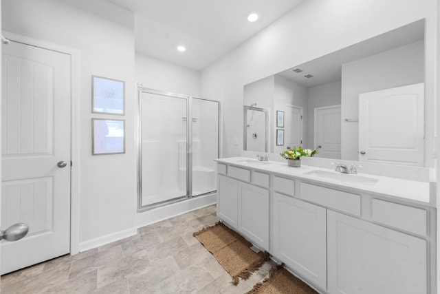 bathroom with vanity and a shower with shower door