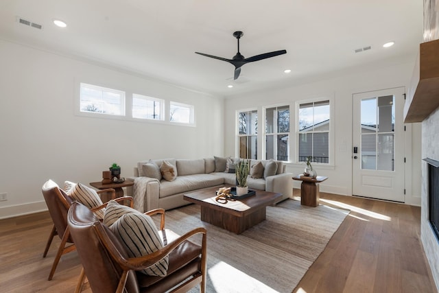 living room featuring hardwood / wood-style floors and ceiling fan