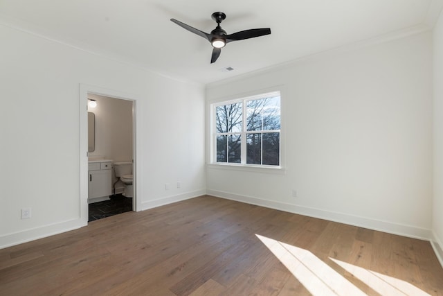 unfurnished bedroom featuring crown molding, hardwood / wood-style flooring, and ensuite bathroom