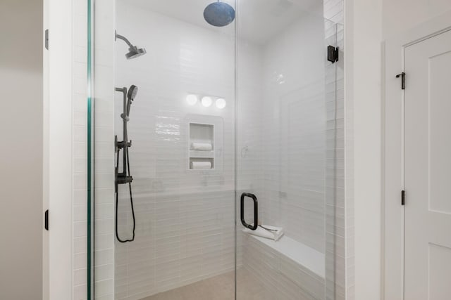 bathroom featuring a shower with door