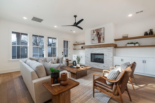 living room with light hardwood / wood-style floors and ceiling fan