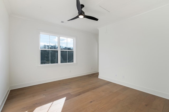 spare room featuring hardwood / wood-style flooring, ornamental molding, and ceiling fan