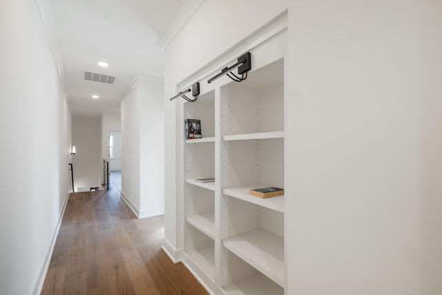 hallway with hardwood / wood-style flooring