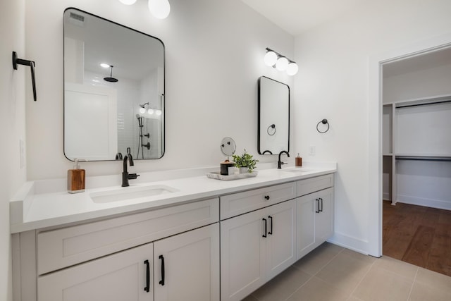 bathroom with vanity, tile patterned flooring, and a shower