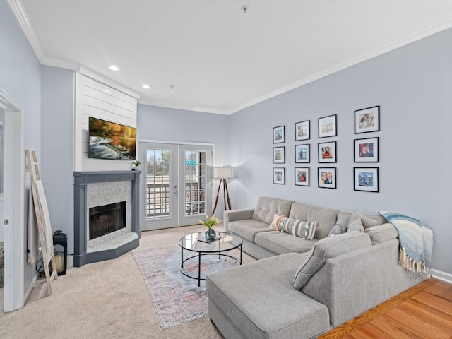 living room with french doors, crown molding, and carpet floors