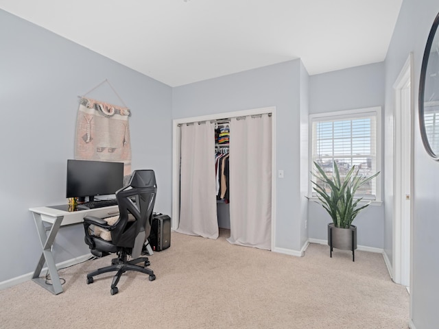 office area featuring light carpet