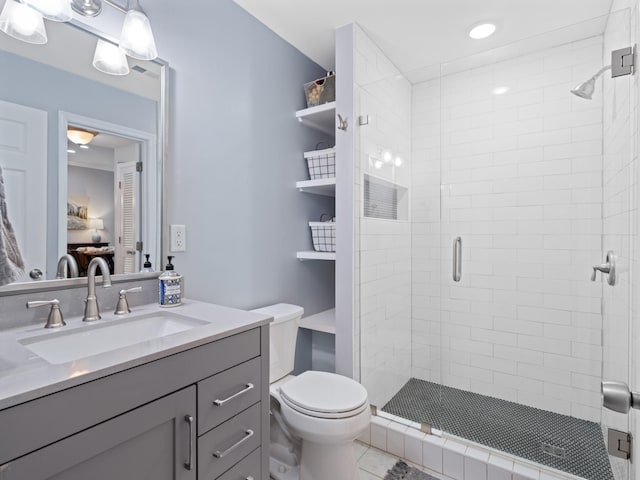 bathroom featuring vanity, an enclosed shower, and toilet