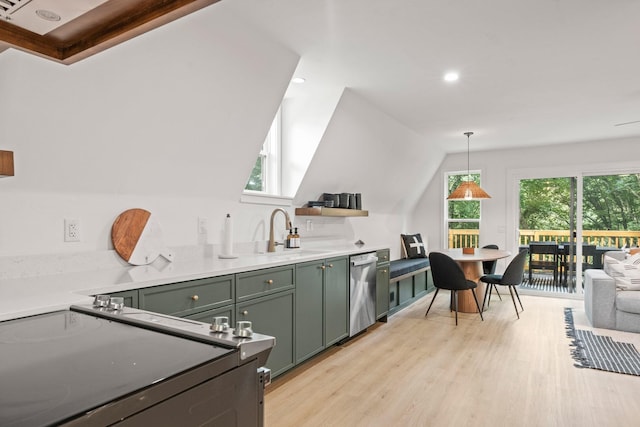 kitchen featuring pendant lighting, sink, lofted ceiling, appliances with stainless steel finishes, and light wood-type flooring