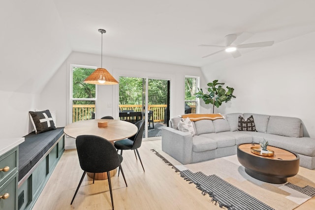 living room featuring ceiling fan, lofted ceiling, and light wood-type flooring