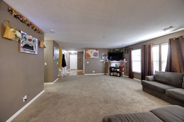 unfurnished living room with light colored carpet and a textured ceiling