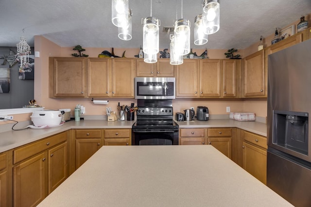 kitchen with stainless steel appliances, decorative light fixtures, and a textured ceiling