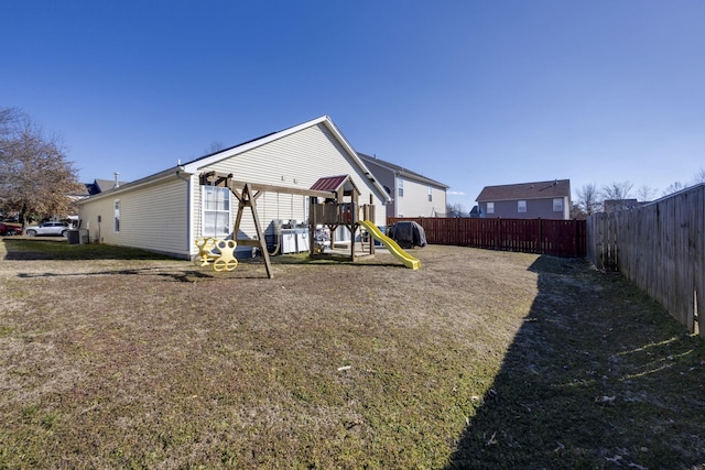 back of property featuring a playground