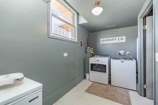 washroom with washing machine and clothes dryer