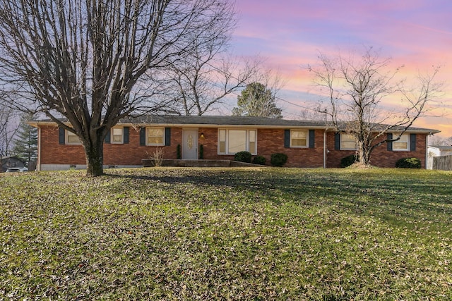 ranch-style home with a lawn