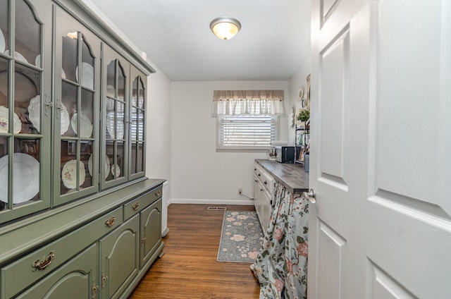 walk in closet with dark hardwood / wood-style flooring