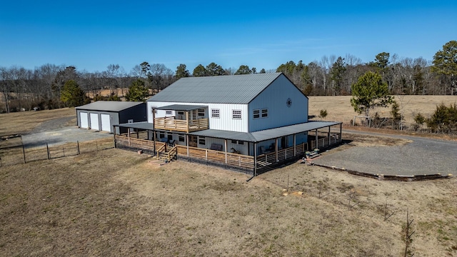 view of front of property with a rural view, an outdoor structure, and a garage