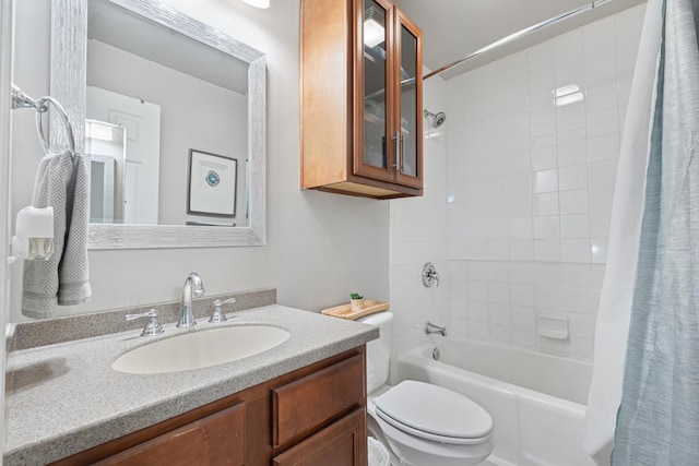 full bathroom with vanity, shower / bath combo, and toilet