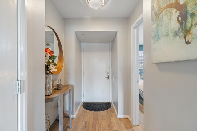 doorway to outside with light wood-type flooring