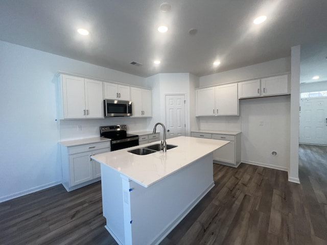 kitchen with white cabinets, a kitchen island with sink, appliances with stainless steel finishes, and a sink