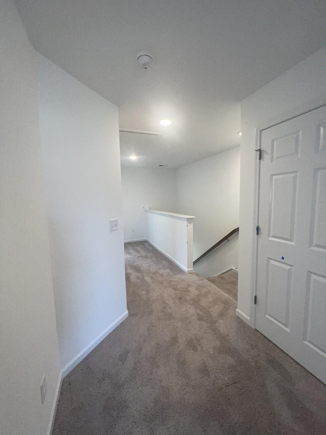 basement featuring carpet flooring and baseboards