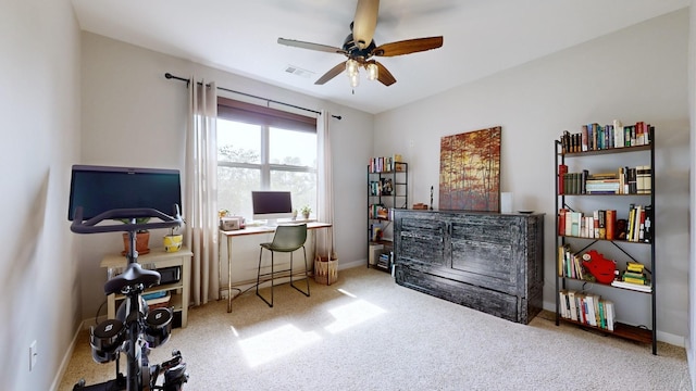 carpeted office space with ceiling fan