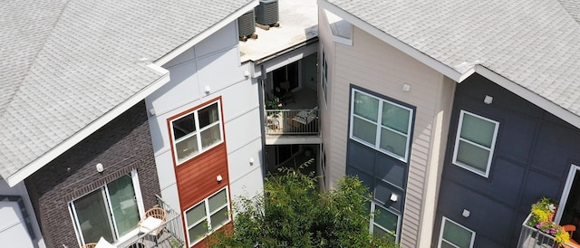 view of side of home featuring central AC unit