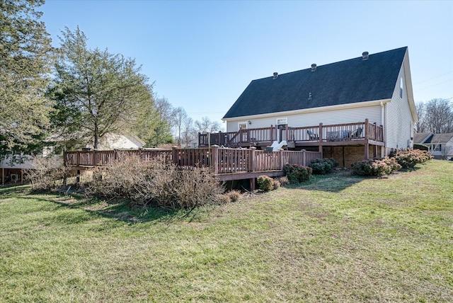 back of property featuring a lawn and a deck