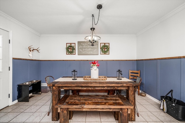 dining area featuring ornamental molding and an inviting chandelier