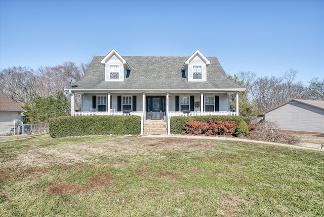 cape cod-style house featuring a porch and a front lawn