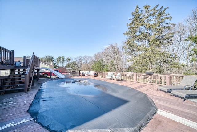 view of swimming pool featuring a deck