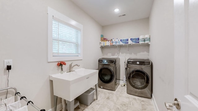 laundry room featuring washer and dryer and sink