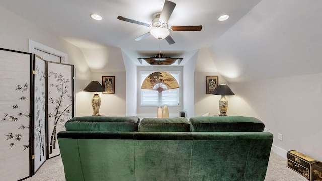 living room featuring ceiling fan, lofted ceiling, and carpet floors