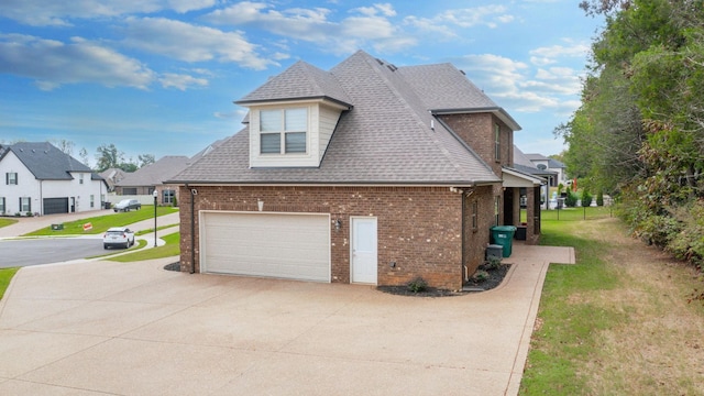 view of side of home with a yard and a garage