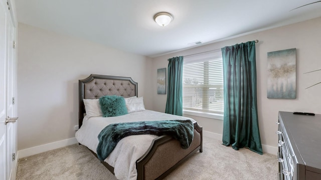 bedroom featuring light carpet