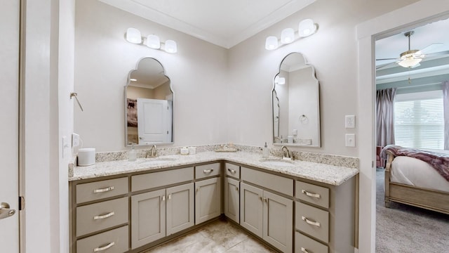 bathroom with crown molding, ceiling fan, and vanity