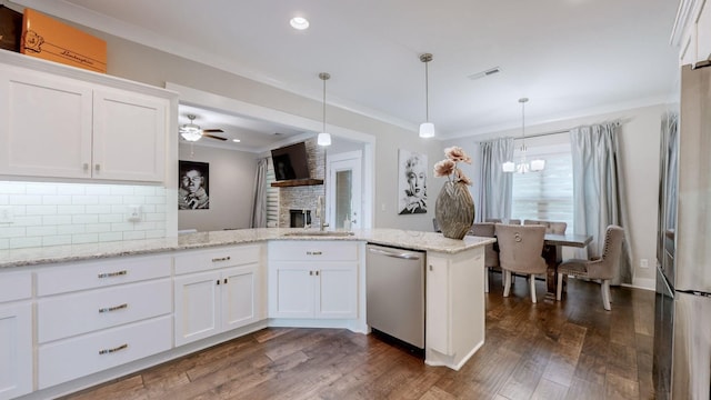 kitchen with white cabinetry, appliances with stainless steel finishes, kitchen peninsula, and sink