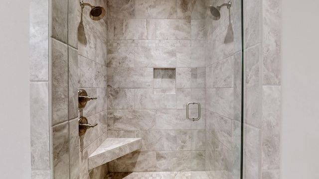 bathroom featuring a shower with shower door