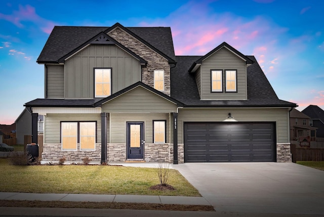 view of front of house featuring a garage and a yard