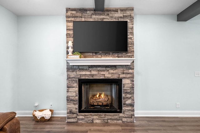 details with hardwood / wood-style flooring, a fireplace, and beamed ceiling