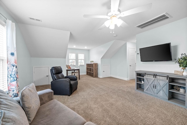 carpeted living room featuring ceiling fan and lofted ceiling