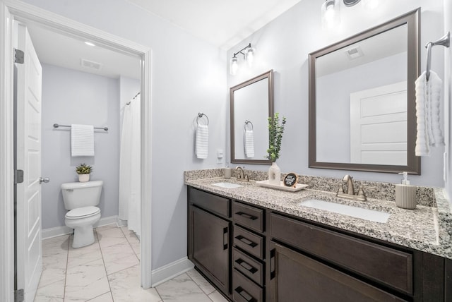 bathroom featuring vanity and toilet