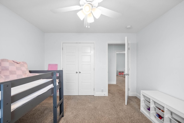 bedroom with light colored carpet, a closet, and ceiling fan