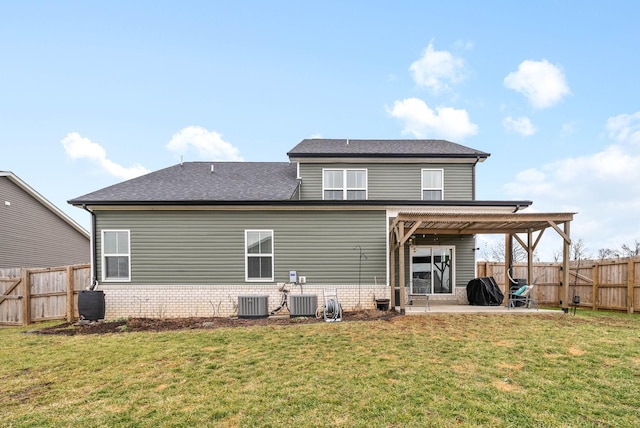 rear view of property with central AC, a patio area, and a lawn