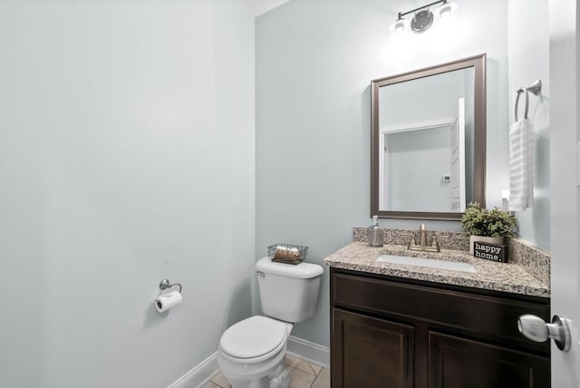 bathroom with vanity, toilet, and tile patterned flooring