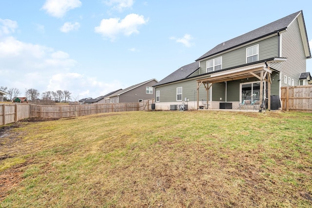 rear view of property featuring central AC unit and a lawn