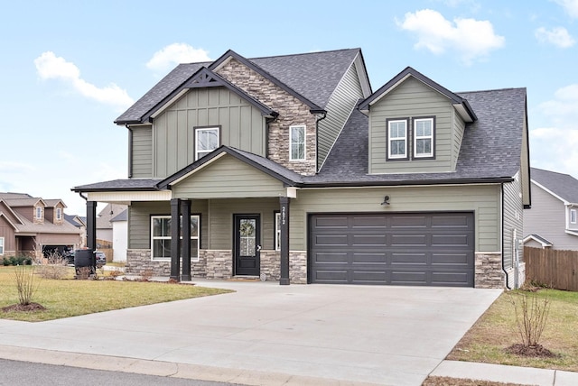 craftsman inspired home with a garage, a front lawn, and covered porch