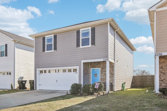 view of front of property featuring a garage and a front yard