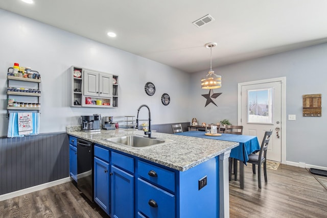 kitchen with black dishwasher, sink, hanging light fixtures, kitchen peninsula, and blue cabinetry